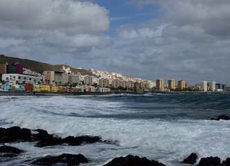 Coastal landscape with strong waves, city and cloudy sky, Las Palmas de Gran Canaria