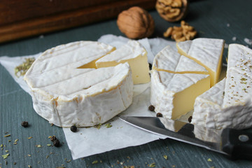 Camembert cheese. Farm products, rustic cheese. Natural cheese, round head of cheese with Camembert...
