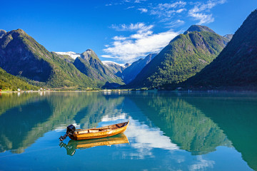 Beautiful Nature Norway natural landscape with fjord, boat and mountain. - 257747244