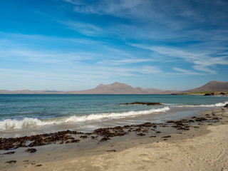 Fototapeta na wymiar Irish west coast, beach Connemara region, county Galway Ireland, peaks of Connemara in the background. Blue sky, sunny day,