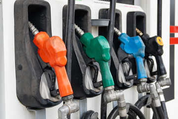 Colorful Petrol pump filling nozzles, Gas station in a service
