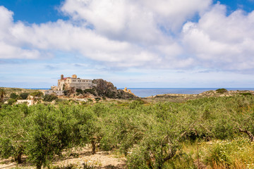 Fototapeta premium Chrisoskalitissa Monastery and olive groves located on the southwest coast of Crete, Greece.