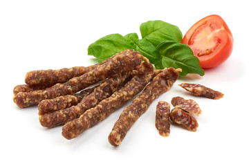 Dried thin pork sausages, smoked meat, close-up, isolated on white background