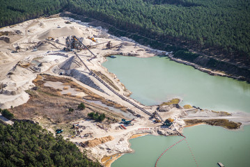 Aerial view of gravel mining and factory plant producing sand materials for the construction...