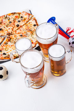 Photo of glasses with foam beer, pizza