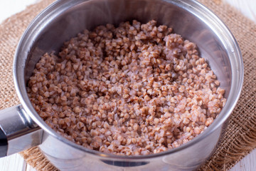 Buckwheat grain in the saucepan on a table