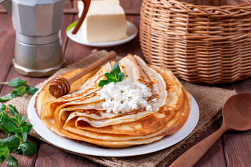 Curd thin pancakes on a white plate. Stack of crepes, russian blin