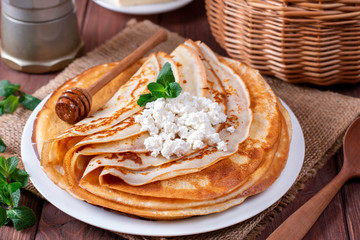 Curd thin pancakes on a white plate. Stack of crepes, russian blin