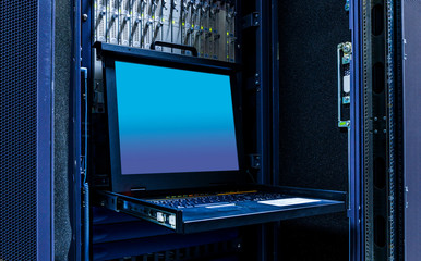 The mainframe server screen and communication racks in data center for large organization