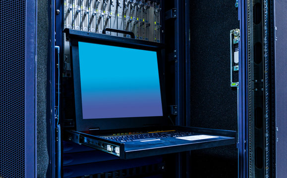 The mainframe server screen and communication racks in data center for large organization