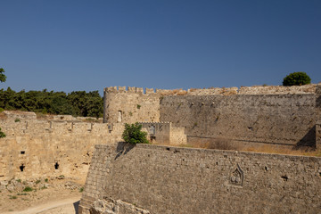 View of the fortress tower, decorated with a metope (sculpture). Gate of St. Athanasius. Rhodes, Greece.
