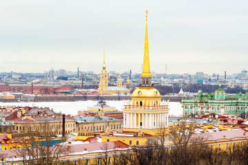Top view of Saint-Petersburg from the roof of Saint Isaacs Cathedral, Russia, snowy roofs and golden spires of amazing buildings on winter day in city, Admiralty building, Peter and Paul Fortress