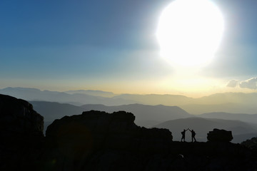 Excited climbers on peaks and success