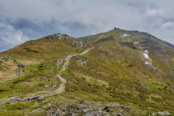 composite landscape. fence near the cross road on hillside meadow in mountains.