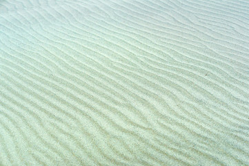 Ripples on the sand. Sea sand. Sandy background. Sandy texture. Natural sea sand and river sand.	