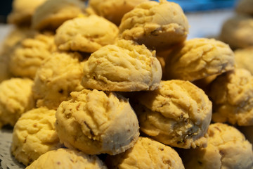 small yellow cookies stacked on a tray