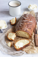 Fototapeta na wymiar Butter and fresh bread. Simple breakfast on grey concrete background.