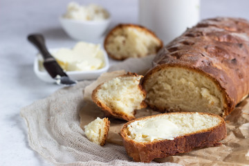 Butter and fresh bread. Simple breakfast on grey concrete background.