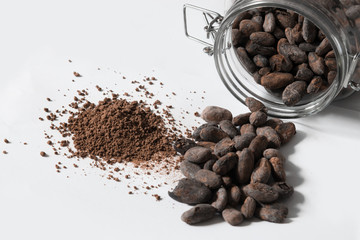 cup of cacao and beans on white background
