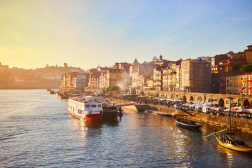 Portugal, Porto old town ribeira aerial promenade view with colorful houses, Douro river and boats.Concept of world travel, sightseeing and tourism