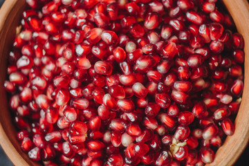 pomegranate grains in a ceramic bowl on a black fabric background, pomegranate fruit, ceramic jug, ceramic plate, isolated still life close up