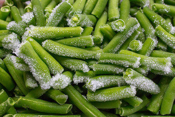 Green sliced beans with frost. Frozen vegetables. Organic food concept. Green chopped kidney beans closeup. Healthy vegetarian food.