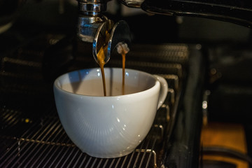 Process of preparation of a cappuccino. Work the barista in coffee shop. Coffee machine