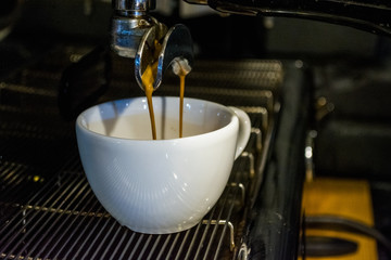 Process of preparation of a cappuccino. Work the barista in coffee shop. Coffee machine