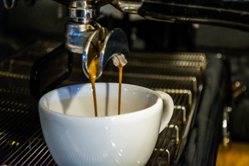 Process of preparation of a cappuccino. Work the barista in coffee shop. Coffee machine