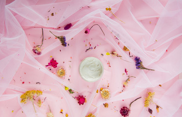 Cream with dry flowers on pink tulle