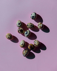 Group of quail eggs on purple background.