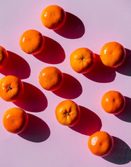 Group of Tangerines on purple background.