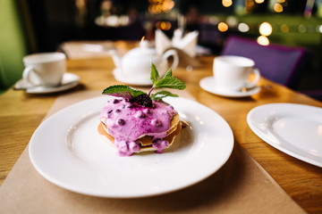 stack of pancakes with jam on white plate with ornate