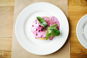 stack of pancakes with jam on white plate with ornate