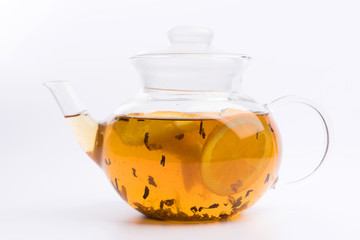 Glass teapot with green tea isolated on white background