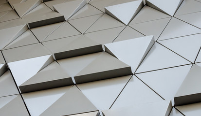 Futuristic Wall of relief metallic triangles. 3d geometric background. low angle view