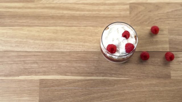 Dessert with raspberries on wooden table