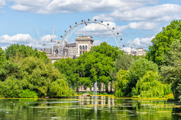 London Eye cityscape view building with St James Park green lake pond on summer day and water fountain in UK - obrazy, fototapety, plakaty
