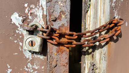 Metallic rusted items. Rust chain and lock mechanism