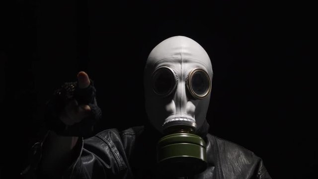 Man wearing a gas mask trying to deliver a message.