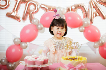 Fototapeta na wymiar toddler girl celebrating her third birthday at home