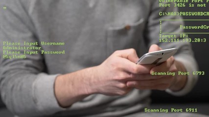 Hacker dressed casually hacking password with a smartphone. Green coding appearing on the screen showing the hacking process.