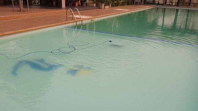 An automatic robot pool cleaner swimming pool removing debris and algae 