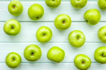 food pattern with green apples on light wooden background top view