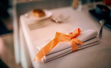 romantic dinner setup, red decoration with candle light in a luxury gastro pub restaurant. Selective focus.  For celebrations and special moments. Decoration light in background.