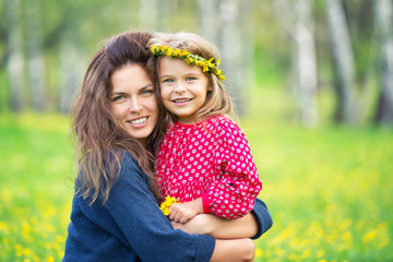 Portrait of happy mother and little daughter in spring park