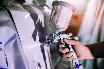 paint sprayer in hand