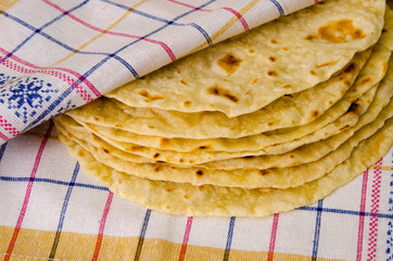 Food. Bakery products. Pita or Indian chapati on textile background.