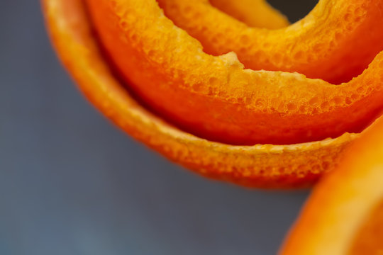 Macro citrus fruit peel. Background with peel a tangerine. Art image with a peel mandarin. Closeup and texture with a peel an orange. A concept for a decor food. Top view. Soft focus. Copy space. © Liubov