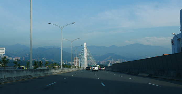  El Poblado and suspension bridge over Medellin river in Medellin, Colombia